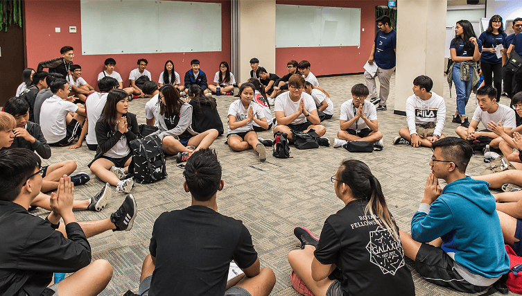 Groups sitting on the floor and having discussion in circle at the workshop program